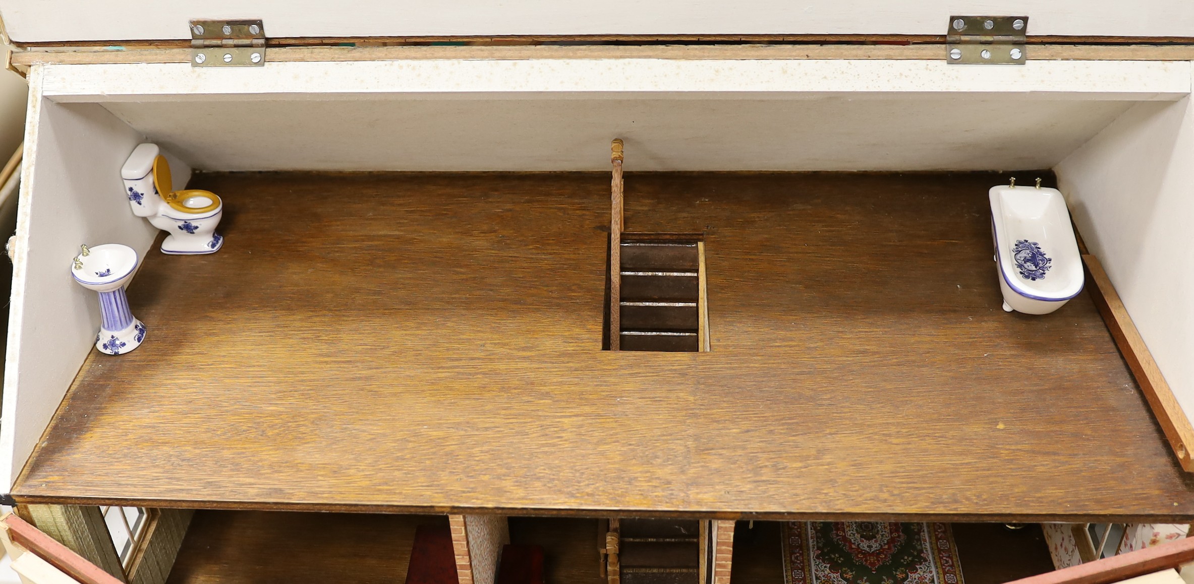 A mid 20th century doll's house and contents, 84cms x 100cms high